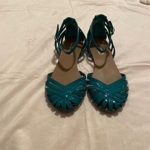 Teal 1980’s style closed-toe ankle strap sandals.